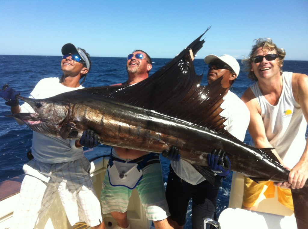 Fishing charter team holding the Sailfish